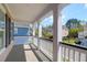 A front porch offers peaceful neighborhood views and features white railings and column supports at 2353 Eagle Creek Dr, Charleston, SC 29414