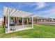 Expansive backyard featuring a pergola, lush lawn, and a view of the surrounding neighborhood at 243 N Light Way, Summerville, SC 29486