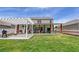 Spacious backyard with a pergola, covered patio, and well-maintained lawn, perfect for outdoor activities at 243 N Light Way, Summerville, SC 29486