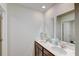 Well-lit bathroom with double vanity, dark cabinets, and decorative seaside accents at 243 N Light Way, Summerville, SC 29486
