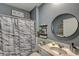 Comfortable bathroom features a shower with tub, single sink, and stylish dark gray color scheme at 243 N Light Way, Summerville, SC 29486