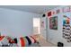 Bright bedroom with a youth-inspired decor, doorway, and neutral color palette at 243 N Light Way, Summerville, SC 29486