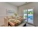 Bright dining area features a rustic wooden table, upholstered chairs, and access to an outdoor patio at 243 N Light Way, Summerville, SC 29486