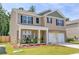 Beautiful two-story home with a welcoming front porch, landscaped garden, and a two-car garage at 243 N Light Way, Summerville, SC 29486
