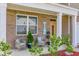 Cozy front porch with seating, decorative plants, and a welcoming entrance at 243 N Light Way, Summerville, SC 29486