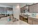 Modern kitchen with granite countertops, stainless steel appliances, and dark wood cabinets at 243 N Light Way, Summerville, SC 29486