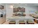 Spacious kitchen island with granite countertops, barstool seating, and stainless steel appliances at 243 N Light Way, Summerville, SC 29486