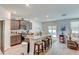 Open kitchen featuring a central island with seating, modern appliances, and a dining area at 243 N Light Way, Summerville, SC 29486