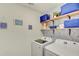 Well-organized laundry room with modern machines, shelving, and decorative touches at 243 N Light Way, Summerville, SC 29486