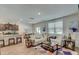 Spacious living room open to dining area and kitchen, complete with hardwood-style floors and neutral decor at 243 N Light Way, Summerville, SC 29486