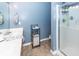 Well-lit bathroom featuring a shower, vanity with sink, and neutral tile flooring at 2431 Thoreau Ln, Charleston, SC 29406