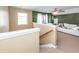 Bedroom features tan walls with white trim, stairs, and ceiling fan at 2431 Thoreau Ln, Charleston, SC 29406