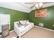 Bedroom features green accent wall, white day bed, ceiling fan, and unique decor at 2431 Thoreau Ln, Charleston, SC 29406