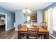 Cozy dining room featuring a wooden table, stylish chandelier, and a view into the kitchen, blending comfort and functionality at 2431 Thoreau Ln, Charleston, SC 29406