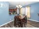 Inviting dining room with wood floors, a chandelier, and blue walls, creating a warm and elegant space for dining at 2431 Thoreau Ln, Charleston, SC 29406