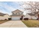 Inviting two-story home featuring neat landscaping, an attached garage, and a welcoming front entrance at 2431 Thoreau Ln, Charleston, SC 29406