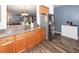 Open-concept kitchen with wood cabinets, stainless steel refrigerator, and breakfast bar, perfect for modern living at 2431 Thoreau Ln, Charleston, SC 29406