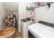 Functional laundry room with washer, dryer, wire rack, and cleaning supplies at 2431 Thoreau Ln, Charleston, SC 29406
