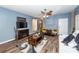 Stylish living room with wood floors, fireplace, modern TV, and seating arrangement at 2431 Thoreau Ln, Charleston, SC 29406