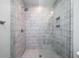 Modern bathroom featuring glass enclosed shower, white vertical tiles and a tiled shower floor at 2501 Clear Marsh Rd, Seabrook Island, SC 29455