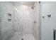 Stylish bathroom featuring floor-to-ceiling white tiles and a glass door shower at 2501 Clear Marsh Rd, Seabrook Island, SC 29455