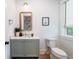 Stylish bathroom with vanity, decorative mirror, toilet, and white walls at 2501 Clear Marsh Rd, Seabrook Island, SC 29455