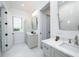 Bright bathroom with dual vanities, tile floor, and a well-lit mirror at 2501 Clear Marsh Rd, Seabrook Island, SC 29455