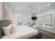 Bright bedroom featuring hardwood floors, neutral walls, a ceiling fan, and large windows providing natural light at 2501 Clear Marsh Rd, Seabrook Island, SC 29455