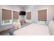 Bright bedroom featuring a TV, large windows for natural light, and a chair to sit and relax at 2501 Clear Marsh Rd, Seabrook Island, SC 29455
