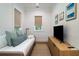 Cozy bedroom with daybed, television, side table, and natural light from the window at 2501 Clear Marsh Rd, Seabrook Island, SC 29455