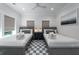 Shared bedroom featuring two twin beds, a shared nightstand, and a black and white checkered rug at 2501 Clear Marsh Rd, Seabrook Island, SC 29455
