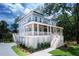Stately two-story home with a charming front porch and beautiful landscaping at 2501 Clear Marsh Rd, Seabrook Island, SC 29455