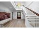 Inviting foyer showcasing a staircase, wooden front door, high ceiling, and hardwood floors at 2501 Clear Marsh Rd, Seabrook Island, SC 29455