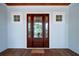 Elegant front door with sidelights and transom window, framed by light-blue siding at 2501 Clear Marsh Rd, Seabrook Island, SC 29455