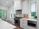 The kitchen has a stainless steel range and ample white cabinets at 2501 Clear Marsh Rd, Seabrook Island, SC 29455