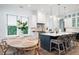 Bright kitchen with island, pendant lights, and dining area with backyard view at 2501 Clear Marsh Rd, Seabrook Island, SC 29455