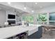Kitchen island with white countertops and farm sink overlooks the open living area at 2501 Clear Marsh Rd, Seabrook Island, SC 29455