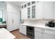 Elegant kitchen with white cabinetry, wine cooler, and beverage center at 2501 Clear Marsh Rd, Seabrook Island, SC 29455