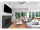 Open living room has fireplace, TV, and large sliding doors to the outdoor area at 2501 Clear Marsh Rd, Seabrook Island, SC 29455