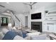 Bright living room features fireplace, TV, stairs and shiplap walls at 2501 Clear Marsh Rd, Seabrook Island, SC 29455