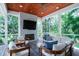 Comfortable outdoor living area with fireplace, plush seating, and serene wooded views at 2501 Clear Marsh Rd, Seabrook Island, SC 29455