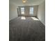 Spacious bedroom with neutral carpeting, two windows, and natural light at 280 Godwit Dr, Summerville, SC 29486