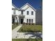 Charming two-story white home with well-manicured lawn and inviting entrance; a perfect suburban haven at 280 Godwit Dr, Summerville, SC 29486