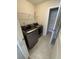 Well-lit laundry room with tile floors, shelving, and front-loading washer and dryer at 280 Godwit Dr, Summerville, SC 29486