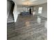 Open-concept living room leading to kitchen with hardwood floors and staircase to the upper level at 280 Godwit Dr, Summerville, SC 29486