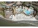 Stunning aerial shot of a beach resort with pools, cabanas, and a sandy beachfront area at 3005 Ocean Winds Dr, Seabrook Island, SC 29455