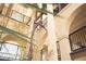 Stunning atrium with tall palm trees, metal giraffe statue, balconies and beautiful stonework at 3005 Ocean Winds Dr, Seabrook Island, SC 29455