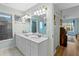 Bright bathroom featuring double sink vanity with white cabinets, shower, and view to the next room at 3005 Ocean Winds Dr, Seabrook Island, SC 29455