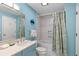 Bright blue bathroom featuring a vanity, tub-shower combo with curtain at 3005 Ocean Winds Dr, Seabrook Island, SC 29455