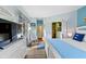 Light-filled bedroom with wood floors, blue accents and access to the bathroom at 3005 Ocean Winds Dr, Seabrook Island, SC 29455